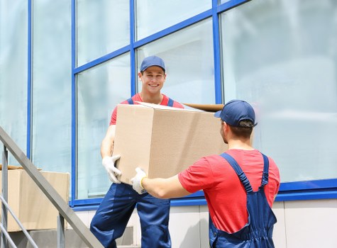 Professional man with a van in Mayfair loading furniture carefully