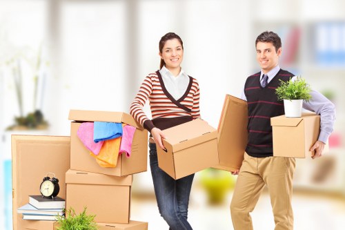 Removal team transporting furniture in a prestigious London property